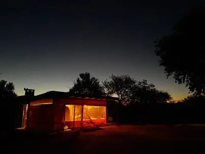 a small cabin with a lit up window at night at las tacanas casa del alto in Nono