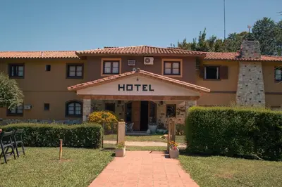 a hotel building with a sign that reads hotel at Hotel Lago Los Molinos in Villa Ciudad de America