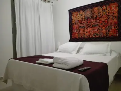 a bed with two towels and a remote control on it at Dpto doña coca alto villasol gama in Cordoba