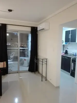 a living room with a white floor and a kitchen at Dpto doña coca alto villasol gama in Cordoba
