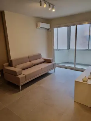 a living room with a couch and a large window at HERMOSO - CATEGORIA Departamento 90 m2 CENTRO con COCHERA opcional in Cordoba