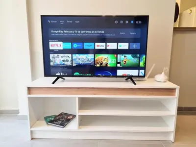 a tv on a white tv stand with a screen at HERMOSO - CATEGORIA Departamento 90 m2 CENTRO con COCHERA opcional in Cordoba
