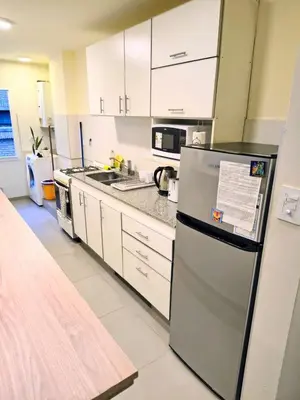 a kitchen with white cabinets and a refrigerator at HERMOSO - CATEGORIA Departamento 90 m2 CENTRO con COCHERA opcional in Cordoba