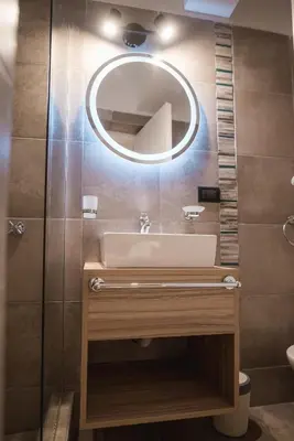 a bathroom with a sink and a mirror at Hotel Libertad in Villa Carlos Paz