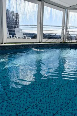 a swimming pool with a view of the water at Hotel Libertad in Villa Carlos Paz