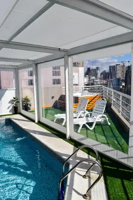a balcony with a swimming pool on a building at Hotel Libertad in Villa Carlos Paz