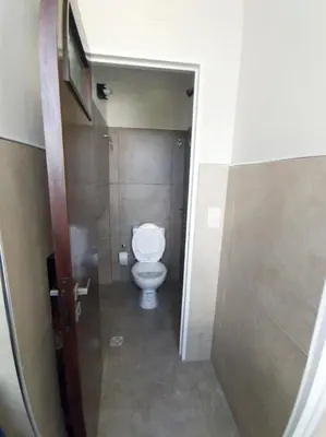 a bathroom with a white toilet in a stall at Departamento Carlos Paz in Villa Carlos Paz