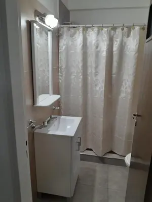 a bathroom with a sink and a shower curtain at Departamento Carlos Paz in Villa Carlos Paz