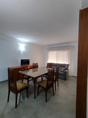 a dining room with a table and chairs and a couch at Departamento Carlos Paz in Villa Carlos Paz