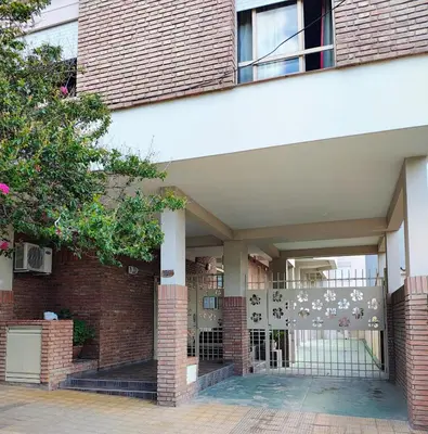 an entrance to a brick building with a gate at Departamento Carlos Paz in Villa Carlos Paz