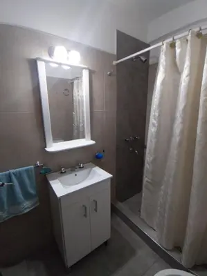 a bathroom with a sink and a shower with a mirror at Departamento Carlos Paz in Villa Carlos Paz