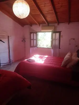 a bedroom with a large bed with a window at Alojamiento x dia Cactus Serrano in Merlo