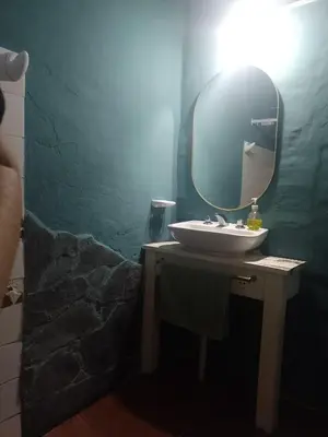 a bathroom with a sink and a mirror at Alojamiento x dia Cactus Serrano in Merlo