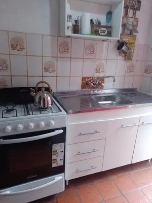 a kitchen with a stove and a sink at Alojamiento x dia Cactus Serrano in Merlo