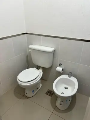 a bathroom with a toilet and a sink at Reserva Tajamar in Alta Gracia