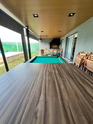 a ping pong table in a house with a pool at Reserva Tajamar in Alta Gracia