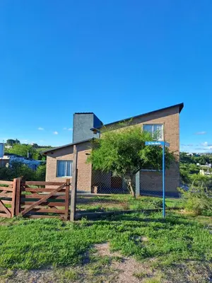 a house with a basketball hoop in front of it at La Casita Estanciera in Estancia Vieja