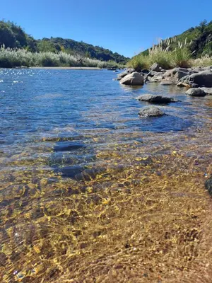 a river with rocks in the water at La Casita Estanciera in Estancia Vieja