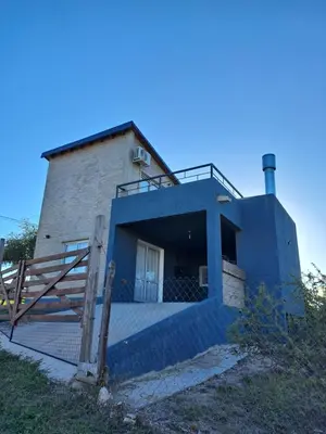 a blue building with a ramp leading up to it at La Casita Estanciera in Estancia Vieja
