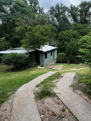 a house with a driveway in front of it at Casa de verano Marcos Lopez in Villa Cura Brochero