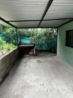an empty parking lot with a large roof at Casa de verano Marcos Lopez in Villa Cura Brochero