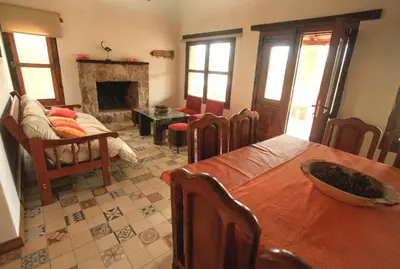 a living room with a table and a fireplace at CASA DE CAMPO COLIBRI EN LA MATILDE in San Javier