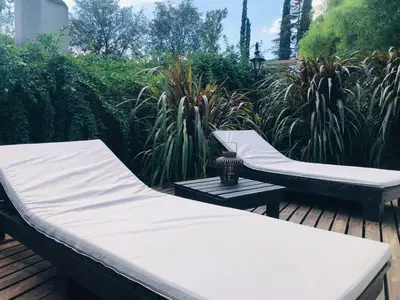 two beds sitting on a wooden deck with plants at Casa en Sierras de Córdoba, Villa la Bolsa. in La Bolsa