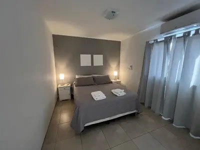 a bedroom with a bed with two towels on it at Depto Siria in Almafuerte
