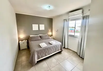a bedroom with a bed with two towels on it at Depto Siria in Almafuerte