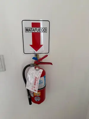 a wall with a fire hydrant and a sign on it at Depto Siria in Almafuerte