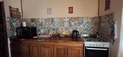 a kitchen with a stove and a counter top at Cabaña Rincón de Afrodita in San Lorenzo