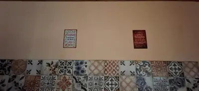 three signs on the wall of a room with tiles at Cabaña Rincón de Afrodita in San Lorenzo