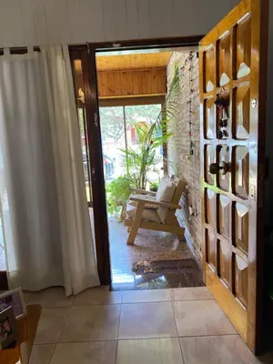 a living room with a door open to a patio at CASA SAN PABLO CENTRO (sólo familias) in Villa Carlos Paz