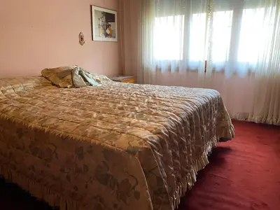 a bedroom with a bed with a blanket on it at CASA SAN PABLO CENTRO (sólo familias) in Villa Carlos Paz