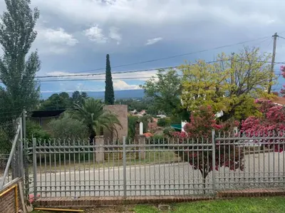 a white fence in front of a yard at Chalet Mariam in Villa Carlos Paz