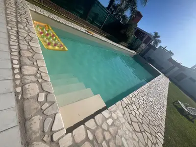 a swimming pool with aogie board in a house at Chalet Mariam in Villa Carlos Paz