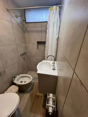 a small bathroom with a sink and a toilet at Chalet Mariam in Villa Carlos Paz