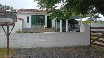 a white house with a fence in front of it at Chalet MAX in Bialet Massé
