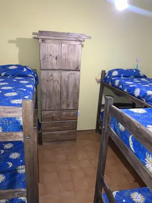 a bedroom with two bunk beds and a wooden cabinet at Chalet MAX in Bialet Massé