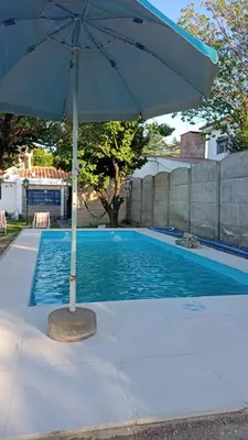 an umbrella sitting next to a swimming pool at Chalet MAX in Bialet Massé