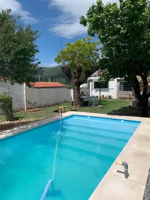 a swimming pool in the backyard of a house at Chalet MAX in Bialet Massé