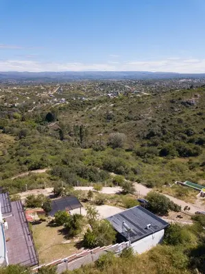 an aerial view of a building in a field at AYRES SUITE in Villa Carlos Paz
