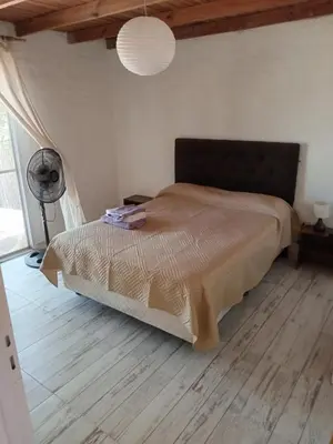 a bedroom with a bed and a fan at Orquídeas in Quebrada de los Pozos