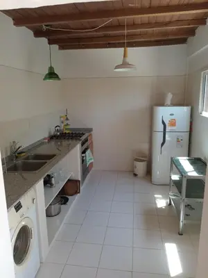 a kitchen with a sink and a refrigerator at Orquídeas in Quebrada de los Pozos