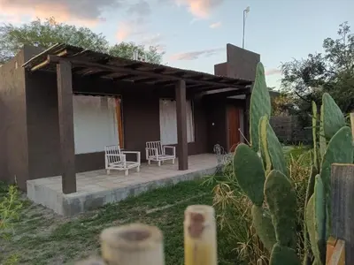 a house with two chairs and a patio at Orquídeas in Quebrada de los Pozos
