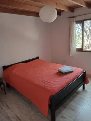 a bedroom with a red bed in a room at Orquídeas in Quebrada de los Pozos