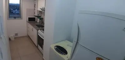 a small kitchen with a sink and a stove at Espacio C Montevideo con estacionamiento in Cordoba