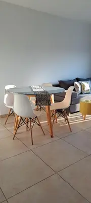 a table and chairs in a living room with a couch at Espacio C Montevideo con estacionamiento in Cordoba