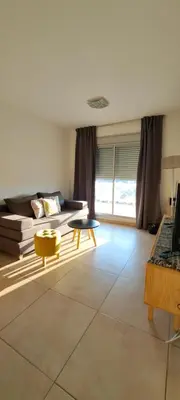 a living room with a couch and a table at Espacio C Montevideo con estacionamiento in Cordoba