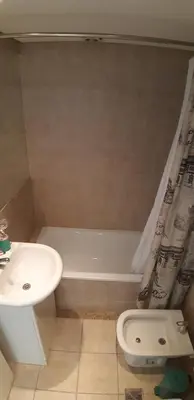 a bathroom with a sink and a tub and a toilet at Espacio C Montevideo con estacionamiento in Cordoba